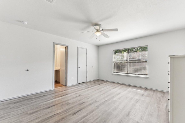 1208 Water Spaniel Way, Round Rock, TX 78664 - unfurnished bedroom with light wood-style floors, ensuite bath, and a ceiling fan