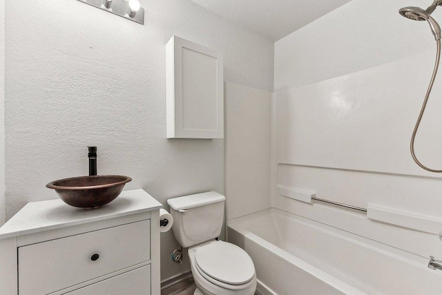 1208 Water Spaniel Way, Round Rock, TX 78664 - full bathroom featuring a textured wall, vanity, toilet, and bathtub / shower combination