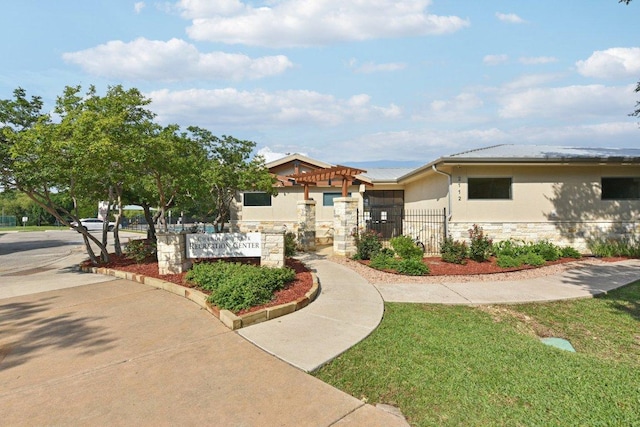 1208 Water Spaniel Way, Round Rock, TX 78664 - view of front facade with a pergola, stone siding, stucco siding, and fence
