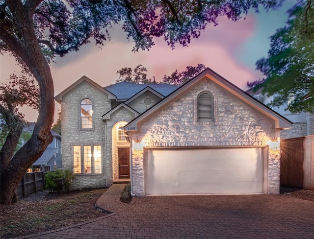 3508 Red River St, Austin, TX 78705 - view of front of home with stone siding, decorative driveway, and a garage