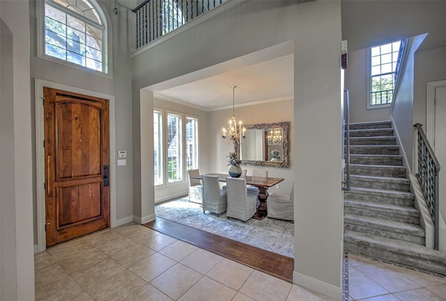 3508 Red River St, Austin, TX 78705 - entrance foyer featuring stairs, a chandelier, baseboards, tile patterned flooring, and ornamental molding