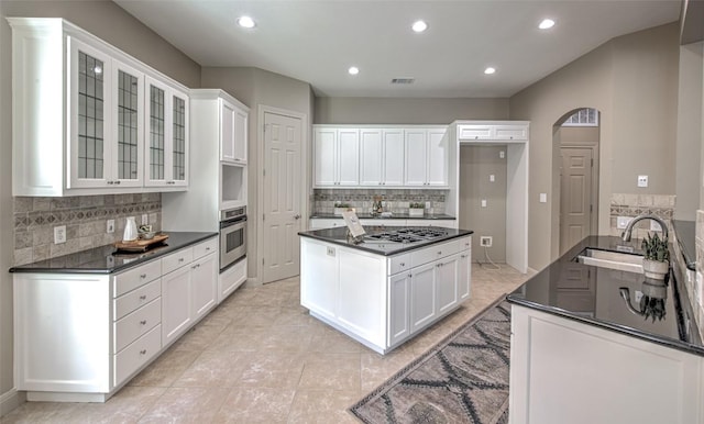 3508 Red River St, Austin, TX 78705 - kitchen with stainless steel oven, dark countertops, a sink, decorative backsplash, and recessed lighting