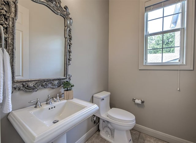 3508 Red River St, Austin, TX 78705 - bathroom with baseboards, toilet, tile patterned floors, and a sink