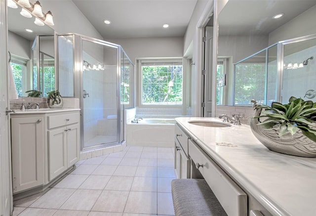 3508 Red River St, Austin, TX 78705 - full bathroom featuring healthy amount of natural light, a garden tub, two vanities, a shower stall, and recessed lighting