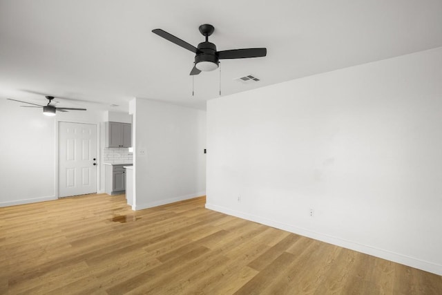 1317 Mckie Cv, Austin, TX 78752 - spare room with a ceiling fan, baseboards, and light wood-style flooring