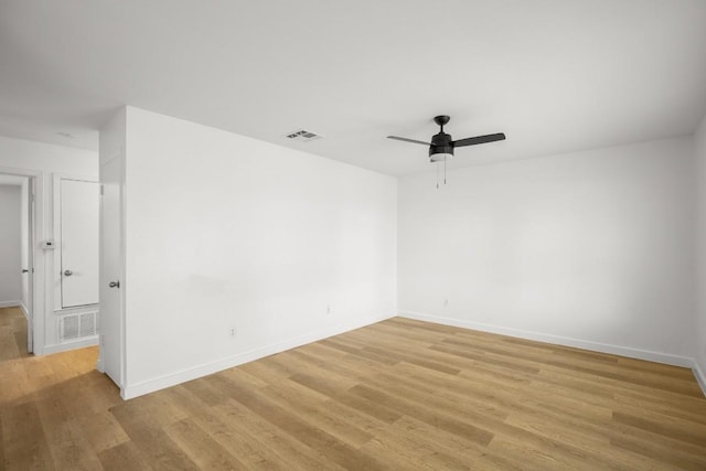 1317 Mckie Cv, Austin, TX 78752 - spare room with a ceiling fan, light wood-style floors, and baseboards