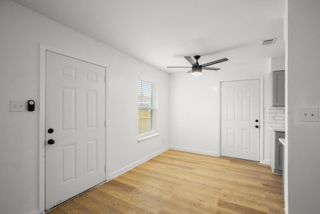 1317 Mckie Cv, Austin, TX 78752 - foyer featuring ceiling fan, light wood-style flooring, and baseboards