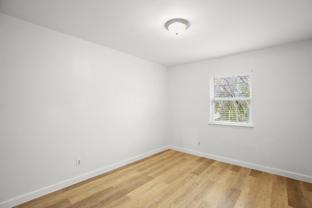 1317 Mckie Cv, Austin, TX 78752 - empty room featuring baseboards and light wood-type flooring