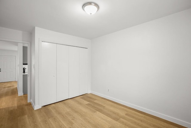 1317 Mckie Cv, Austin, TX 78752 - unfurnished bedroom with light wood-style flooring, baseboards, and a closet