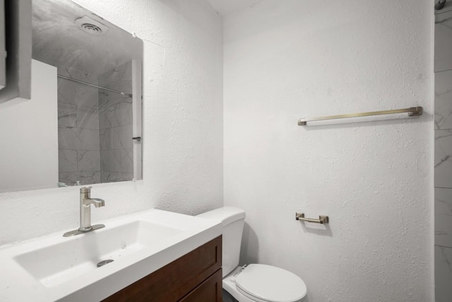 1317 Mckie Cv, Austin, TX 78752 - full bathroom with toilet, vanity, and a shower