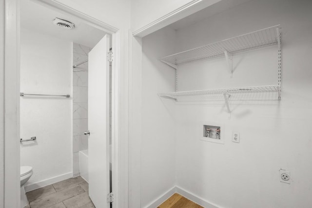 1317 Mckie Cv, Austin, TX 78752 - washroom featuring hookup for an electric dryer, washer hookup, and baseboards