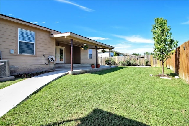 113 Hawkins Ln, Jarrell, TX 76537 - fenced backyard featuring a patio area and french doors