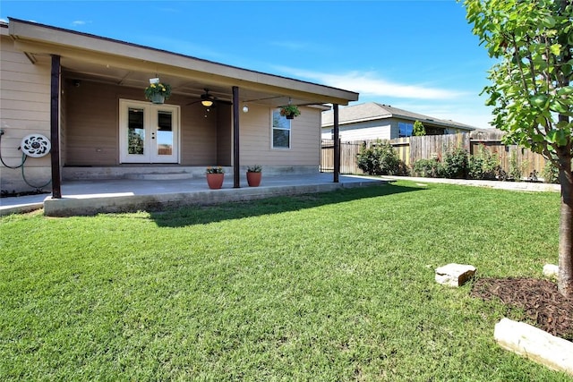 rear view of house with ceiling fan, a patio area, and french doors