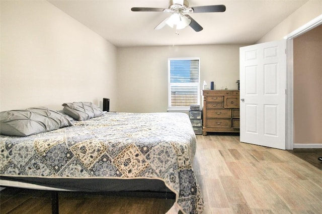 bedroom with light wood-style floors, ceiling fan, and baseboards