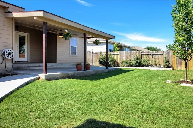 view of yard featuring ceiling fan and a patio area