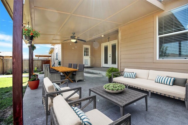 view of patio with french doors, an outdoor living space, fence, ceiling fan, and outdoor dining space