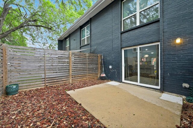 3820 Southway Dr Unit C, Austin, TX 78704 - back of house featuring fence, a patio area, and brick siding