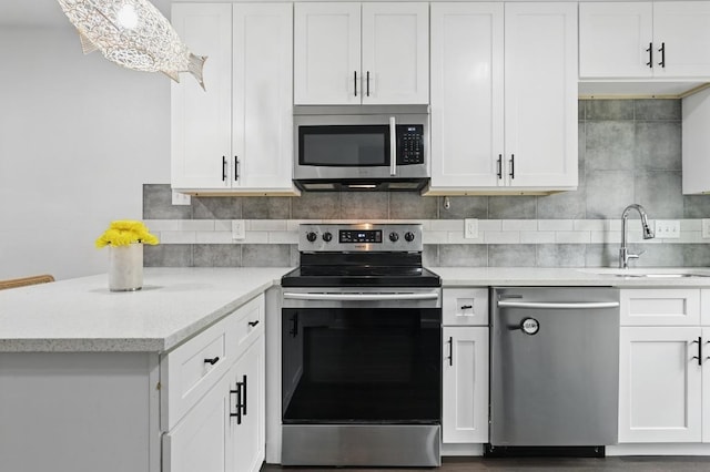 3820 Southway Dr Unit C, Austin, TX 78704 - kitchen with stainless steel appliances, a sink, white cabinetry, and decorative backsplash