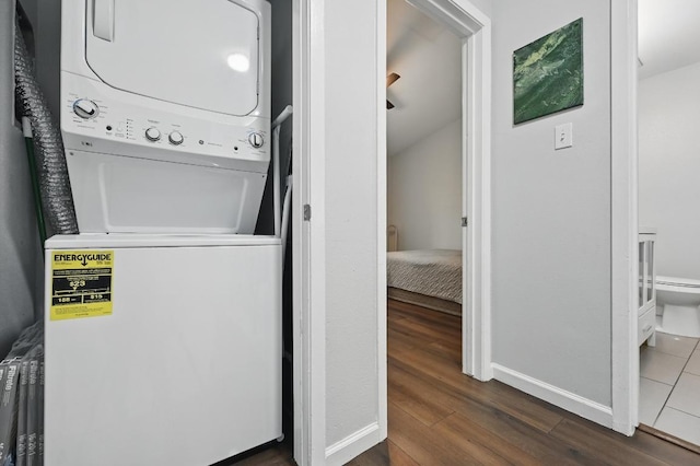 3820 Southway Dr Unit C, Austin, TX 78704 - washroom featuring estacked washer and dryer, dark wood-style floors, and baseboards