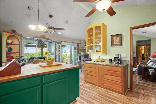 6906 Chinook Dr, Austin, TX 78736 - kitchen with lofted ceiling, a ceiling fan, wooden counters, light wood-type flooring, and a textured ceiling