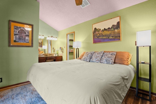 6906 Chinook Dr, Austin, TX 78736 - bedroom with vaulted ceiling, a textured ceiling, and wood finished floors