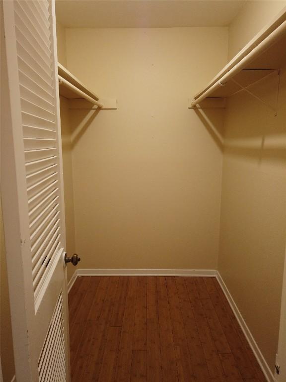 1000 W 26th St Unit 110, Austin, TX 78705 - spacious closet with dark wood-style flooring