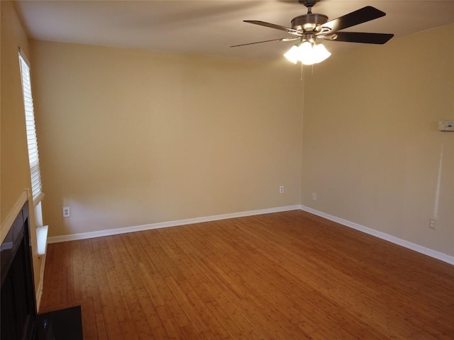 1000 W 26th St Unit 110, Austin, TX 78705 - empty room featuring wood finished floors, a ceiling fan, and baseboards