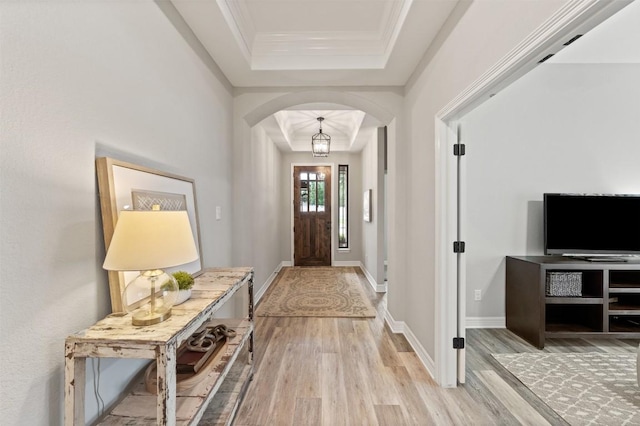 10515 Bryson Dr, Temple, TX 76502 - entryway with a raised ceiling, arched walkways, light wood-type flooring, crown molding, and baseboards