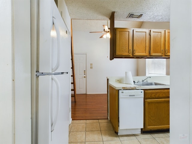 2210 Pearl St Unit 306, Austin, TX 78705 - kitchen featuring white appliances, a sink, a ceiling fan, light countertops, and brown cabinets