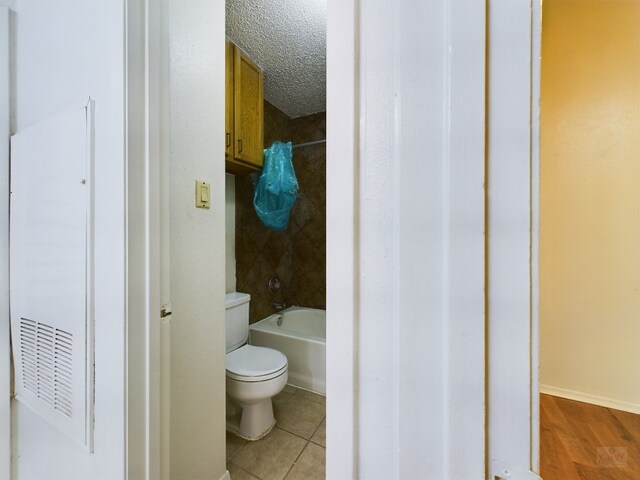 2210 Pearl St Unit 306, Austin, TX 78705 - bathroom featuring toilet, bathing tub / shower combination, and tile patterned floors