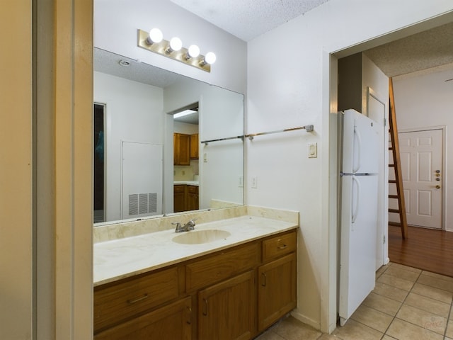 2210 Pearl St Unit 306, Austin, TX 78705 - bathroom featuring tile patterned flooring, vanity, and a textured ceiling