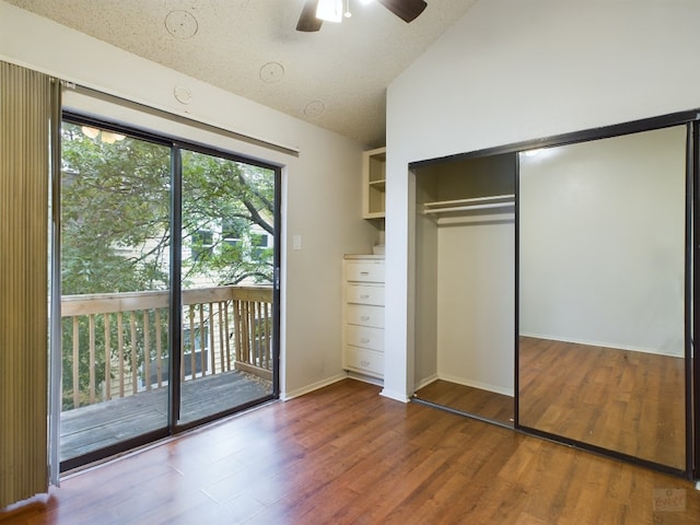 2210 Pearl St Unit 306, Austin, TX 78705 - unfurnished bedroom featuring access to outside, wood finished floors, a closet, vaulted ceiling, and a ceiling fan