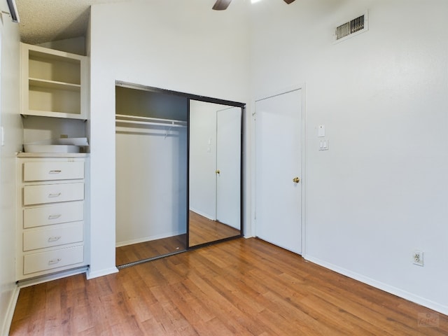2210 Pearl St Unit 306, Austin, TX 78705 - unfurnished bedroom with light wood-style flooring, a closet, baseboards, and a ceiling fan