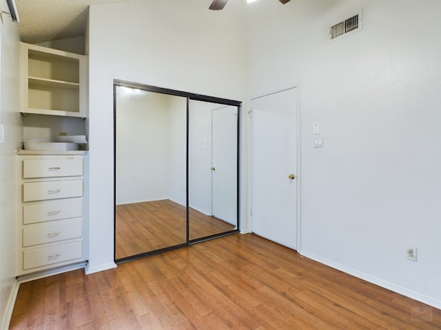 2210 Pearl St Unit 306, Austin, TX 78705 - unfurnished bedroom featuring light wood-type flooring, a closet, baseboards, and ceiling fan