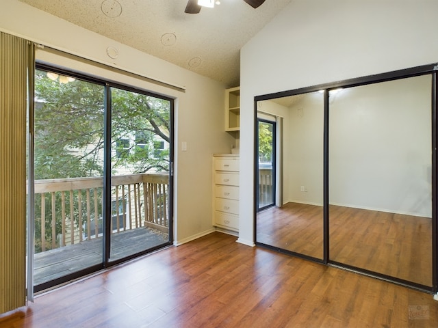 2210 Pearl St Unit 306, Austin, TX 78705 - unfurnished bedroom with access to outside, lofted ceiling, wood finished floors, a closet, and a ceiling fan
