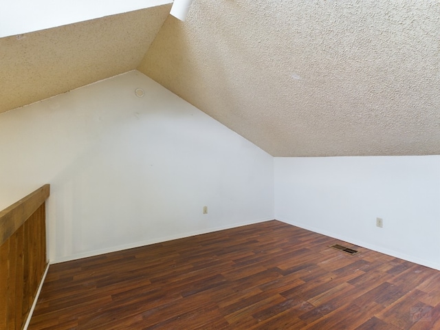 2210 Pearl St Unit 306, Austin, TX 78705 - additional living space with wood finished floors, vaulted ceiling, and baseboards