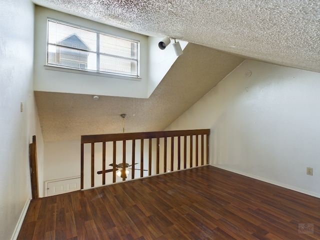 2210 Pearl St Unit 306, Austin, TX 78705 - additional living space featuring wood finished floors, a textured ceiling, and vaulted ceiling