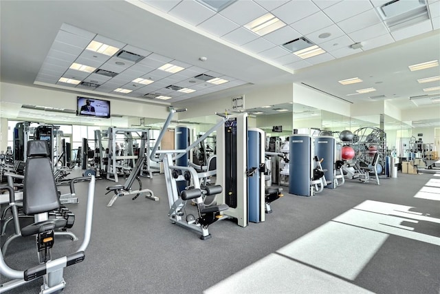 exercise room with a paneled ceiling