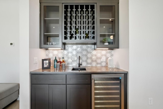 2308 Kahala Sunset Dr, Spicewood, TX 78669 - indoor wet bar featuring beverage cooler and decorative backsplash