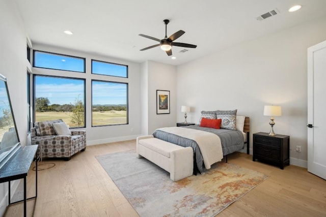 bedroom with light wood-style flooring, baseboards, recessed lighting, and a ceiling fan