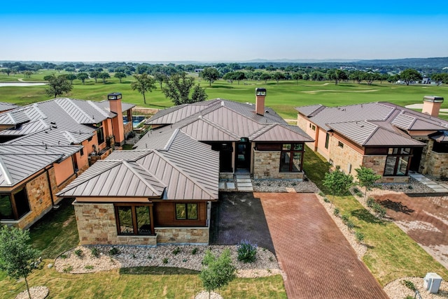 aerial view of property and surrounding area featuring a golf course