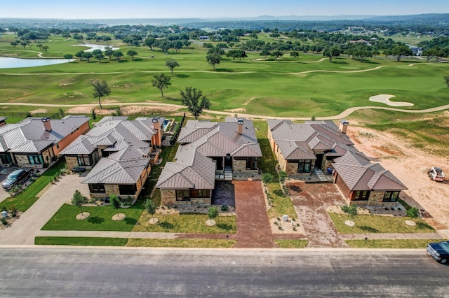 drone / aerial view of a nearby body of water and a golf club