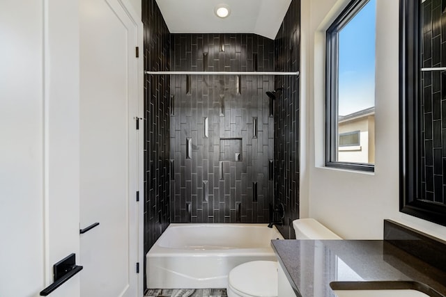 full bath with plenty of natural light, toilet, vanity, and shower / washtub combination