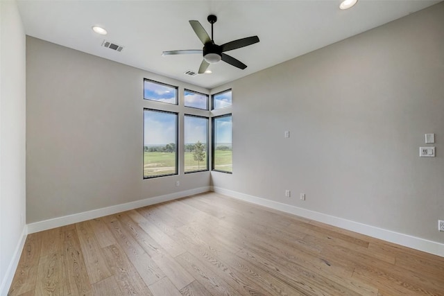 unfurnished room with light wood-style flooring, a ceiling fan, baseboards, and recessed lighting