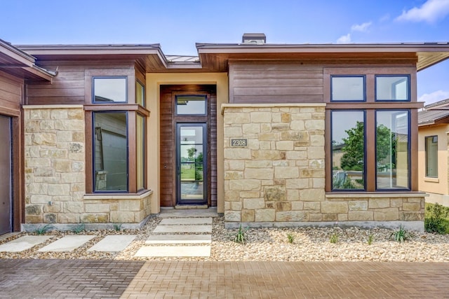 entrance to property with stone siding