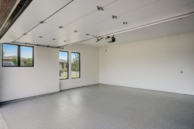 spare room featuring speckled floor and baseboards