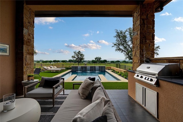 balcony featuring area for grilling, exterior kitchen, outdoor lounge area, view of pool, and a patio area