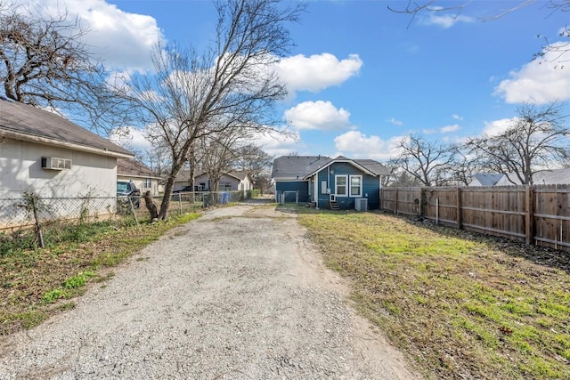 3225 Homan Ave, Waco, TX 76707 - view of front of house with dirt driveway, fence, and an AC wall unit