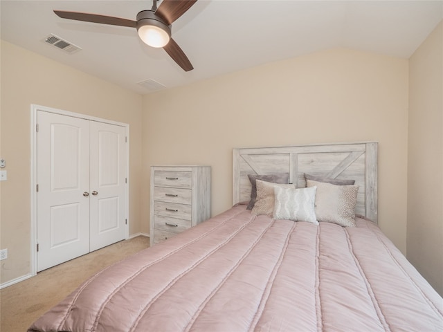 carpeted bedroom with lofted ceiling, ceiling fan, and a closet