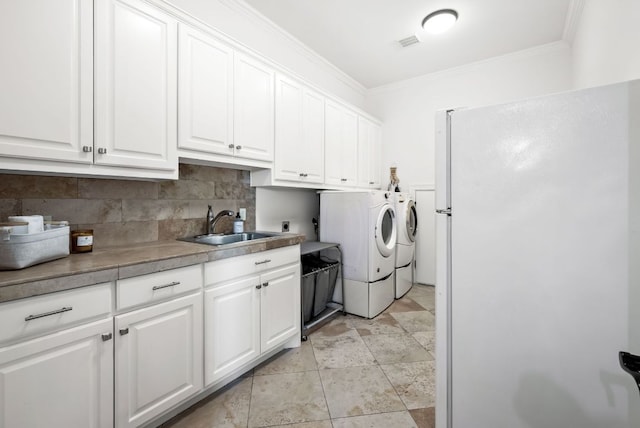 4020 Texas Wildlife Trl, Austin, TX 78735 - clothes washing area featuring cabinet space, washer and clothes dryer, and crown molding